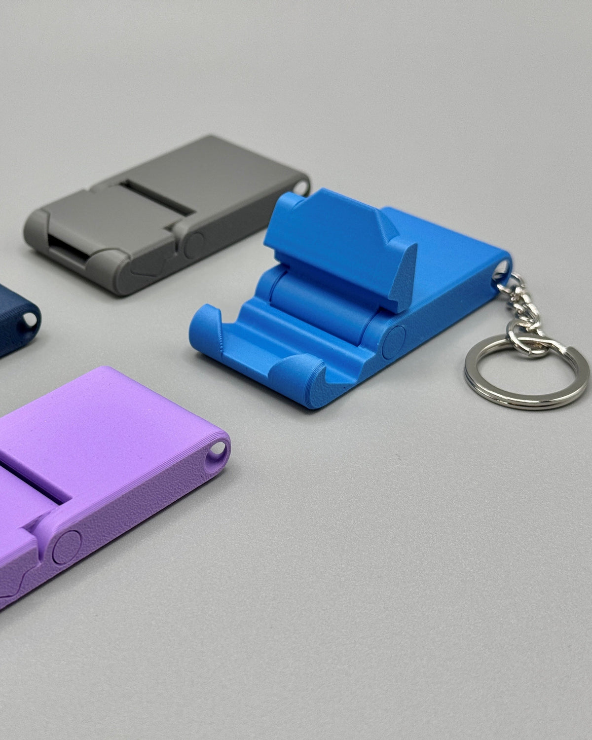 Four colorful plastic clips on a gray background